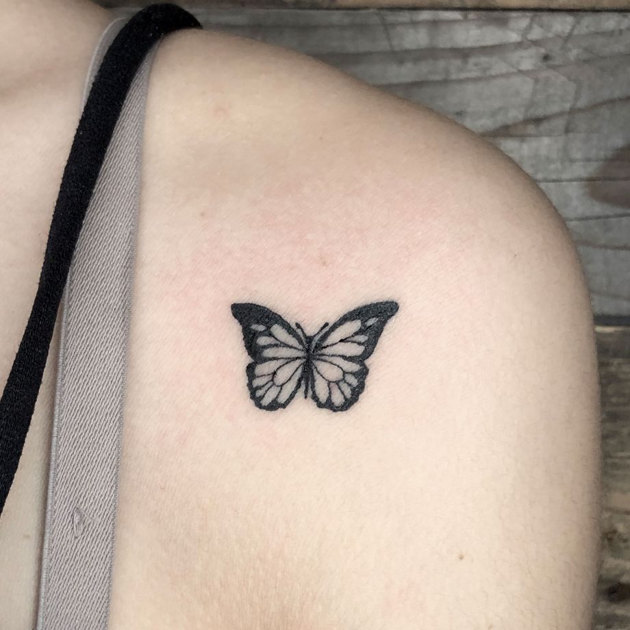 Tatuaje black work de una mariposa en el hombro